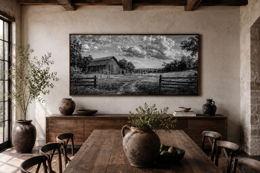 Black and white barn landscape canvas wall art in a rustic dining room with wooden furniture.