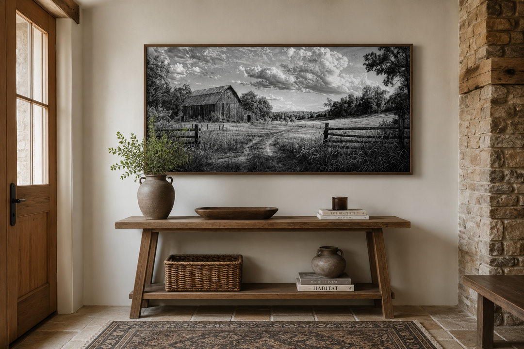 Black and white barn landscape canvas wall art above a rustic wooden console table.