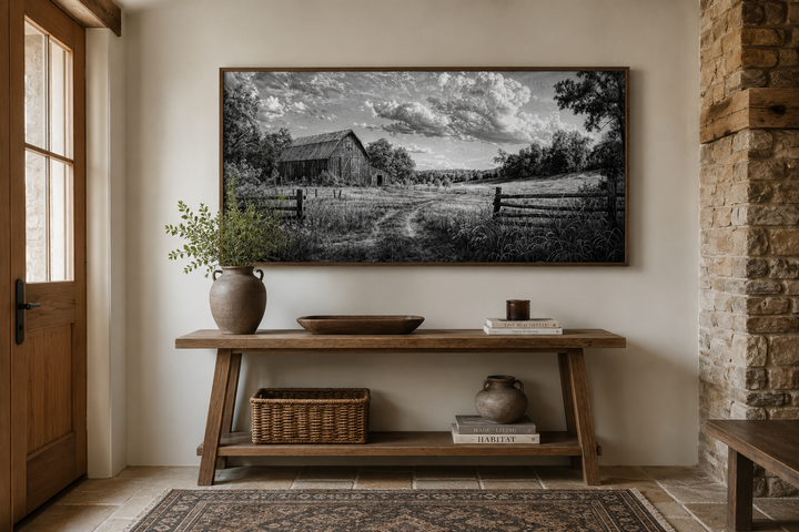 Black and white barn landscape canvas wall art above a rustic wooden console table.
