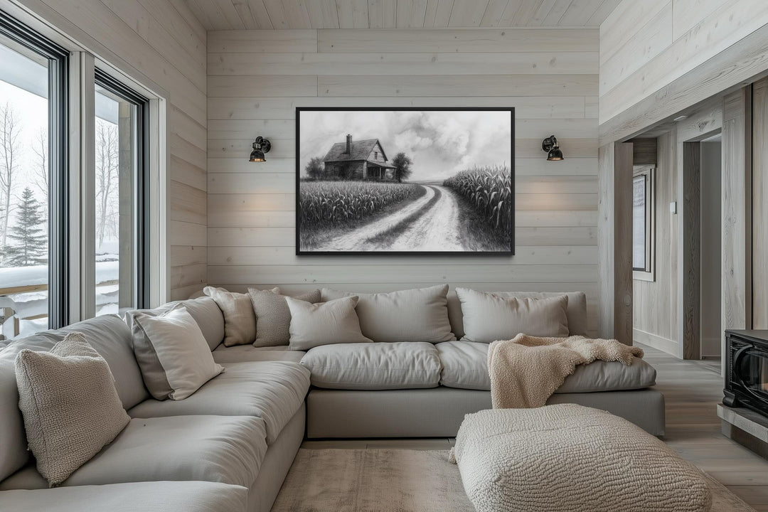 Black and white farmhouse wall art featuring a cornfield landscape above a neutral sectional sofa.