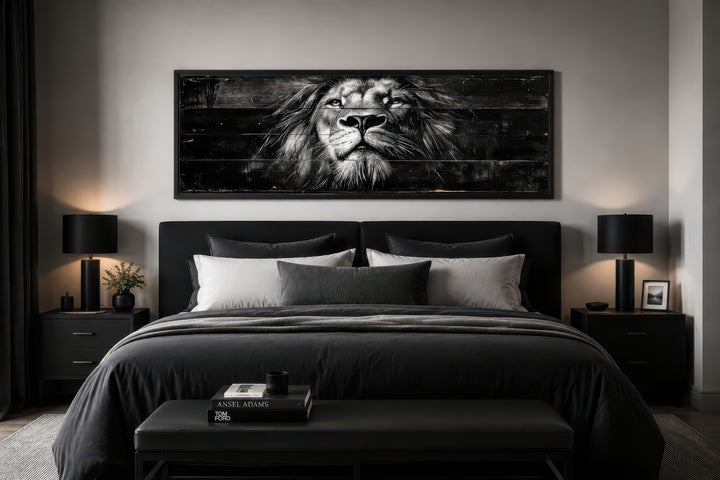 Black and white lion horizontal canvas wall art centered above a bed in a modern masculine bedroom.