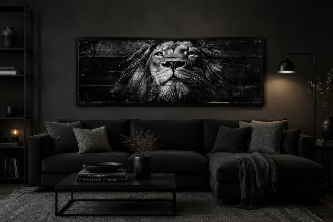 Black and white lion horizontal canvas wall art above a black sofa in a dark, modern living room.