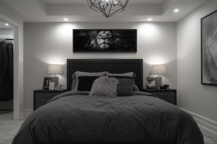 Black and white lion horizontal canvas wall art centered above a bed in a modern bedroom.