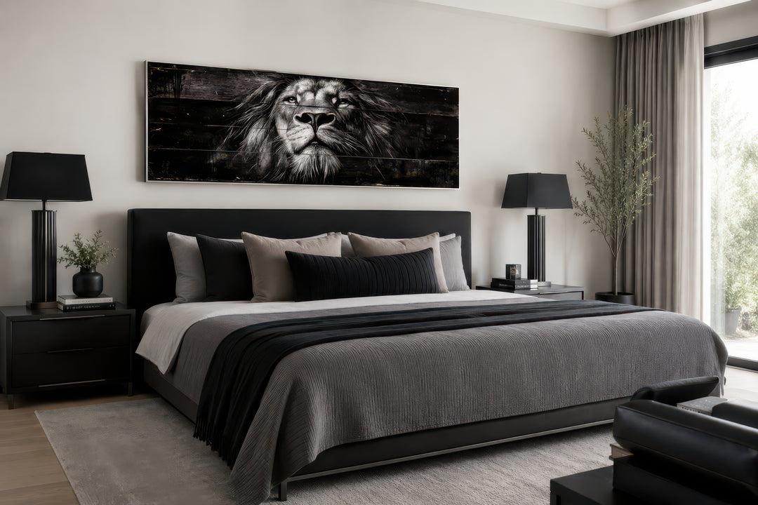 Black and white lion face canvas wall art centered above a bed in a modern masculine bedroom.