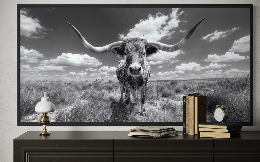 Black and white framed canvas wall art featuring a longhorn bull in a wide landscape.