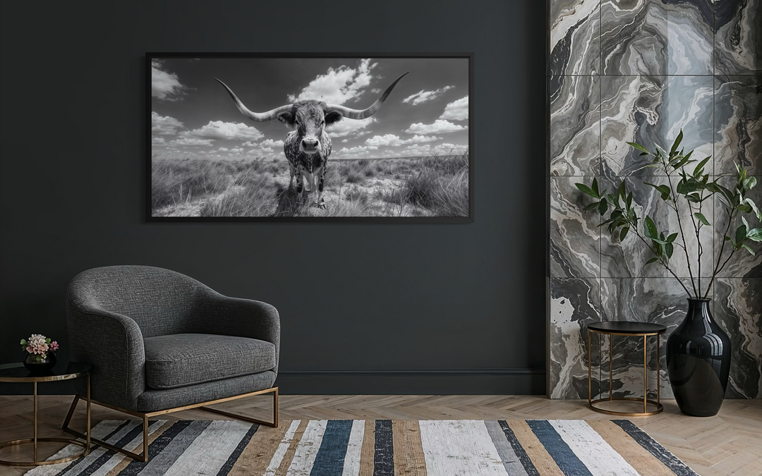 Black and white longhorn photography style framed canvas wall art in a modern living room.