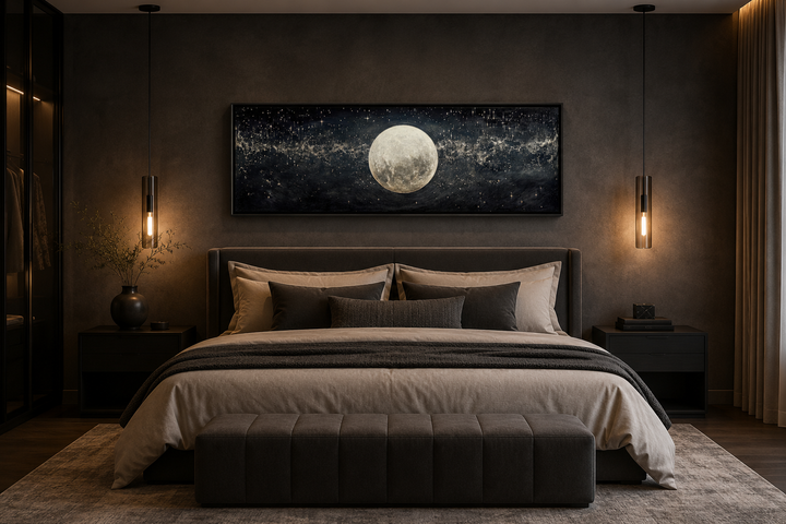 Black and white horizontal canvas print of a full moon in a starry sky hanging above a bed.