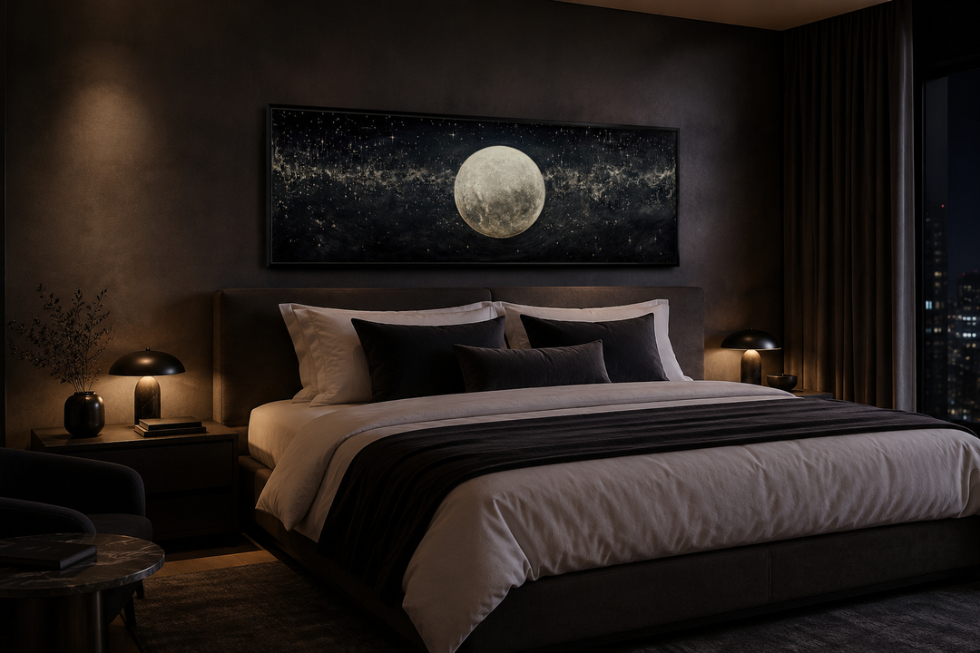 Horizontal canvas print of a glowing full moon in a starry night sky hung above a bed.