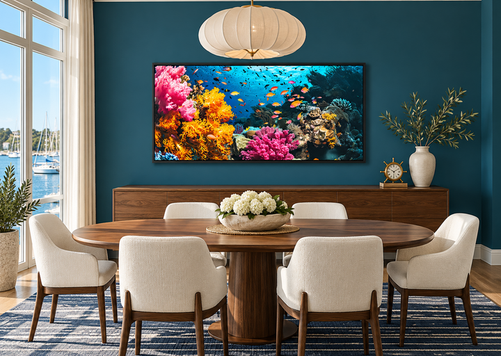 Underwater coral reef and fish photography wall art in a black frame above a dining room sideboard.