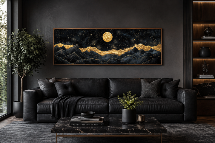 Black gold mountain wall art canvas print with a moonlit night landscape above a black sofa.