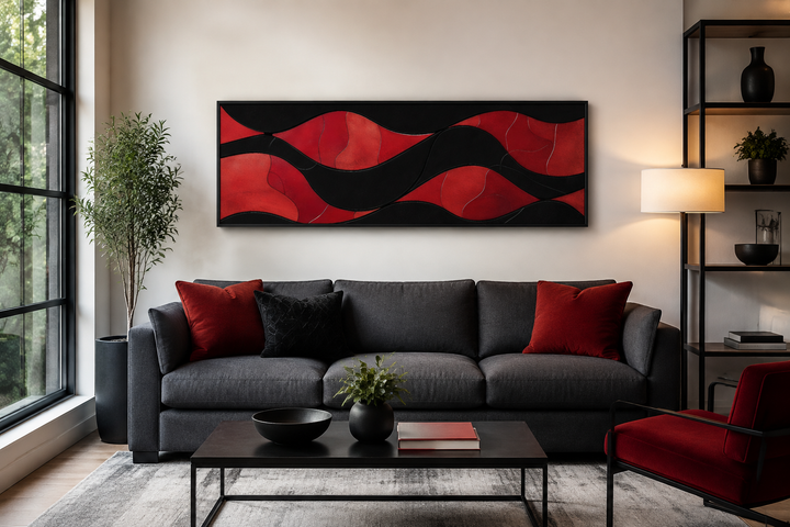 Black and red modern abstract horizontal framed canvas wall art above a dark grey sofa.