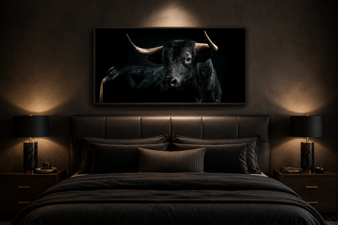 Extra large framed canvas wall art of a black Spanish bull hanging above a bed in a modern room.