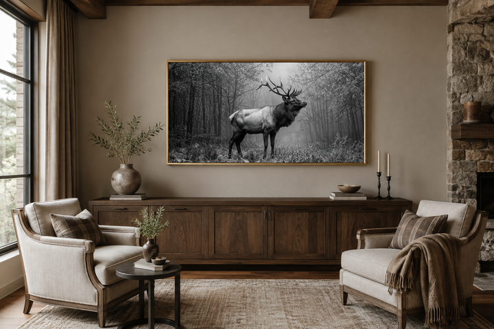 Elk stag in a forest black and white photography framed canvas wall art in a rustic living room.