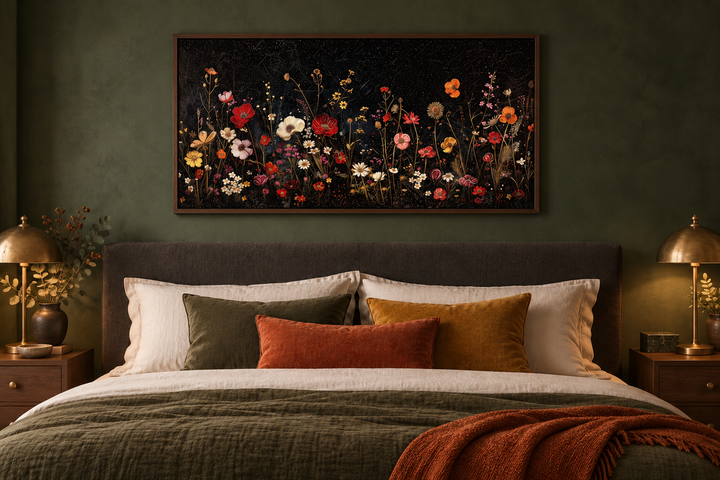 Framed canvas wall art of colorful wildflowers in a night field above a bed in a green bedroom.