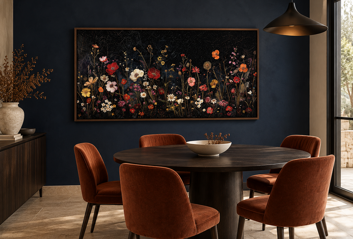 Framed canvas wall art of colorful wildflowers in a night field above a dark wood dining table.