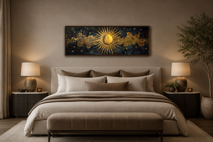 Black and gold sun long narrow horizontal framed canvas wall art hanging above a bed.