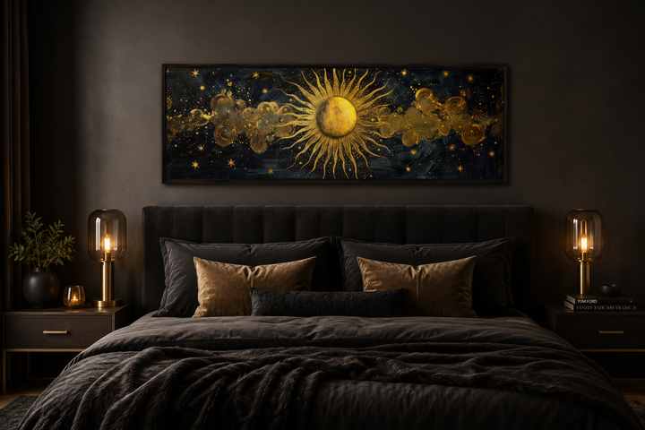 Black and gold sun long narrow horizontal framed canvas wall art hanging above a bed.