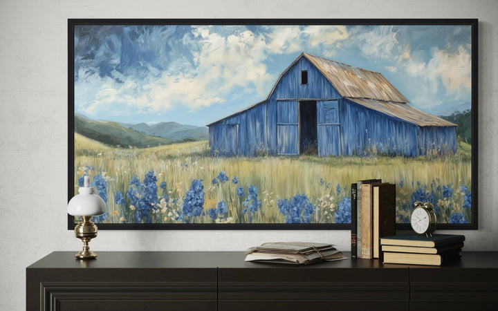 Rustic framed canvas wall decor featuring a blue barn and bluebonnets in a rural landscape.