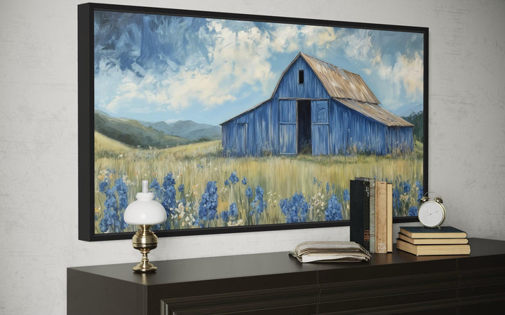 Blue barn and bluebonnets rustic framed canvas wall decor above a dark wood dresser.