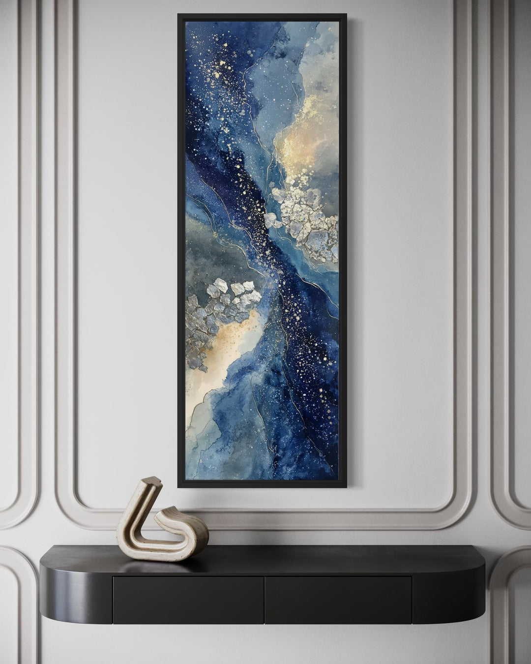 Tall narrow abstract canvas print featuring navy, beige, and gold tones in a black frame.