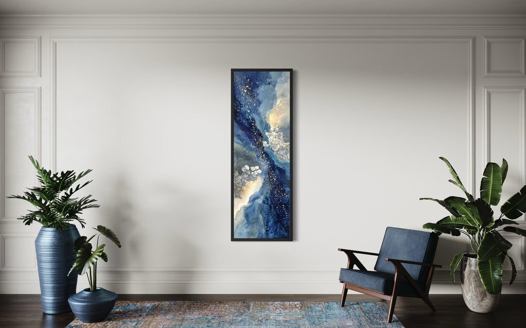 Tall narrow abstract canvas print featuring navy, beige, and gold tones in a vertical black frame.
