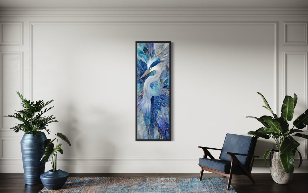 Vertical canvas print of an elegant heron in navy blue and sapphire tones on a white wall.