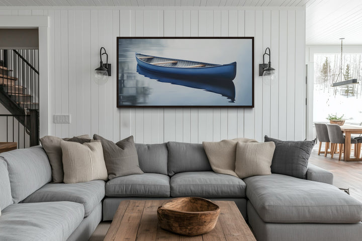 Blue Canoe Wall Art framed canvas above a gray sectional sofa in a modern lake house living room.