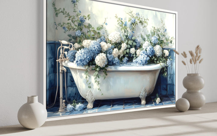 Canvas print of a vintage clawfoot tub overflowing with blue and white hydrangeas in a bathroom.