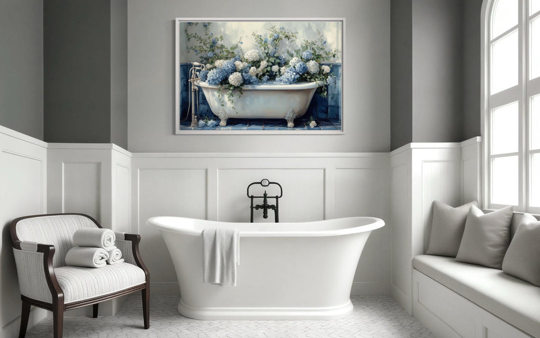 Canvas print of blue and white hydrangeas in a vintage clawfoot tub hanging in a modern bathroom.