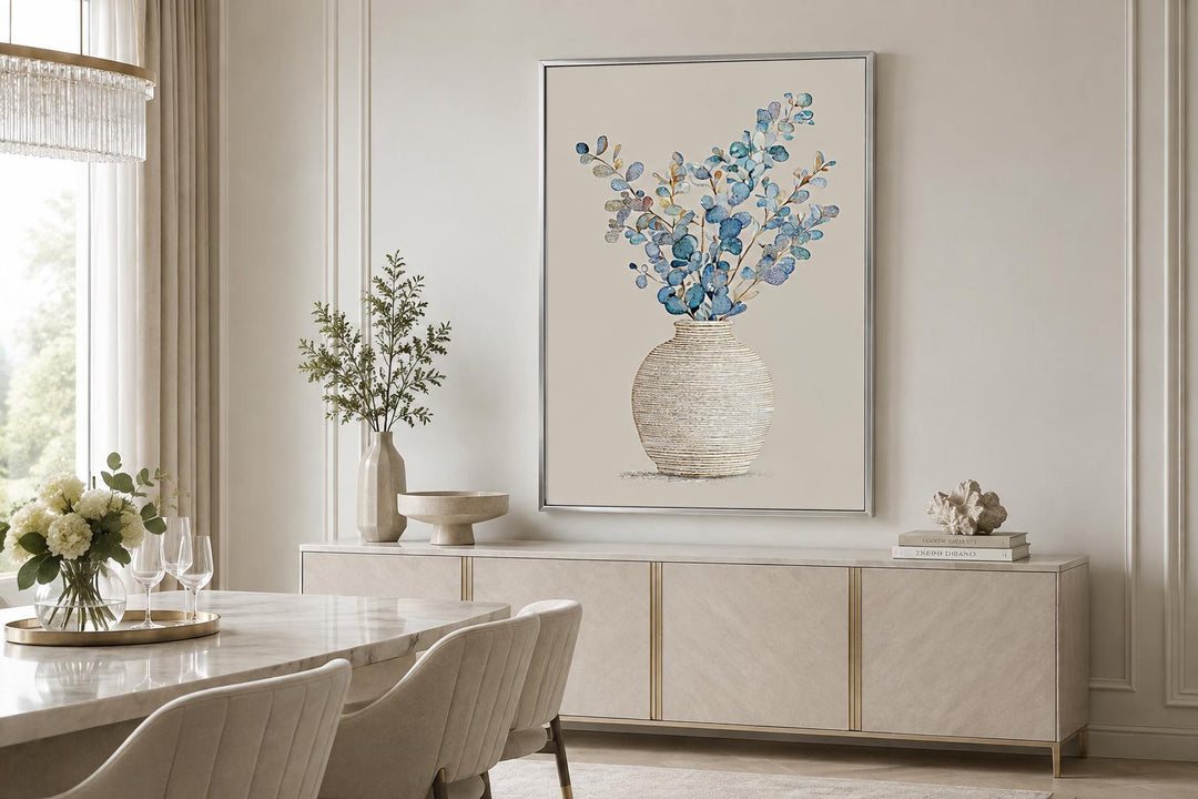 Blue floral still life wall art with eucalyptus-style branches in a textured vase and gold frame.