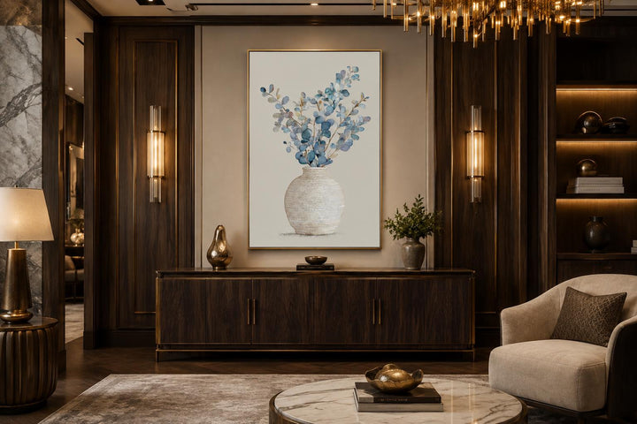 Blue floral still life wall art with eucalyptus branches in a textured vase and gold frame.