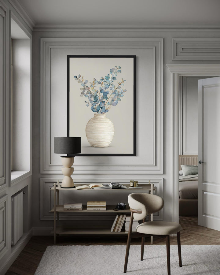 Blue floral still life wall art featuring eucalyptus branches in a textured vase on a cream wall.