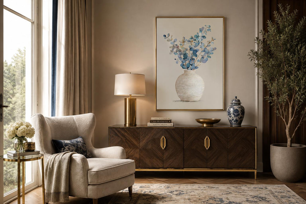 Blue floral still life wall art with eucalyptus branches in a textured vase and gold frame.