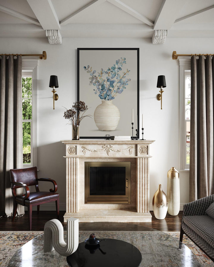 Blue floral still life wall art with eucalyptus branches in a textured vase over a fireplace.