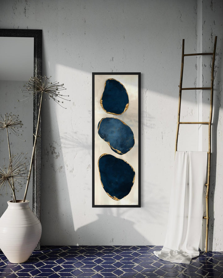 Vertical narrow canvas print featuring three stacked blue abstract stones with gold edges.