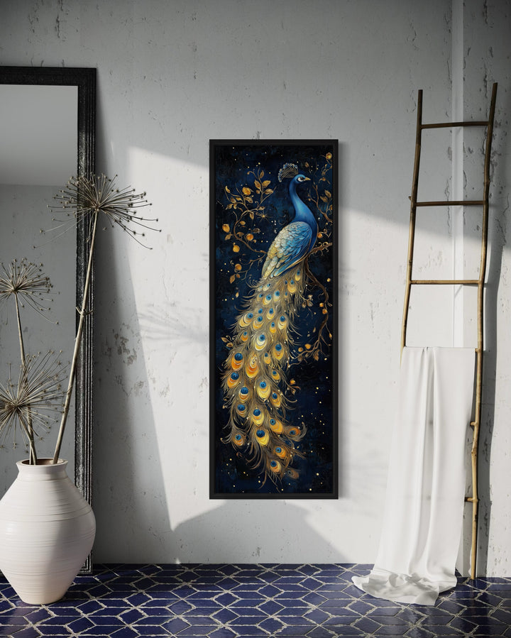 Tall narrow vertical framed canvas wall art featuring a blue and gold peacock on a navy background.