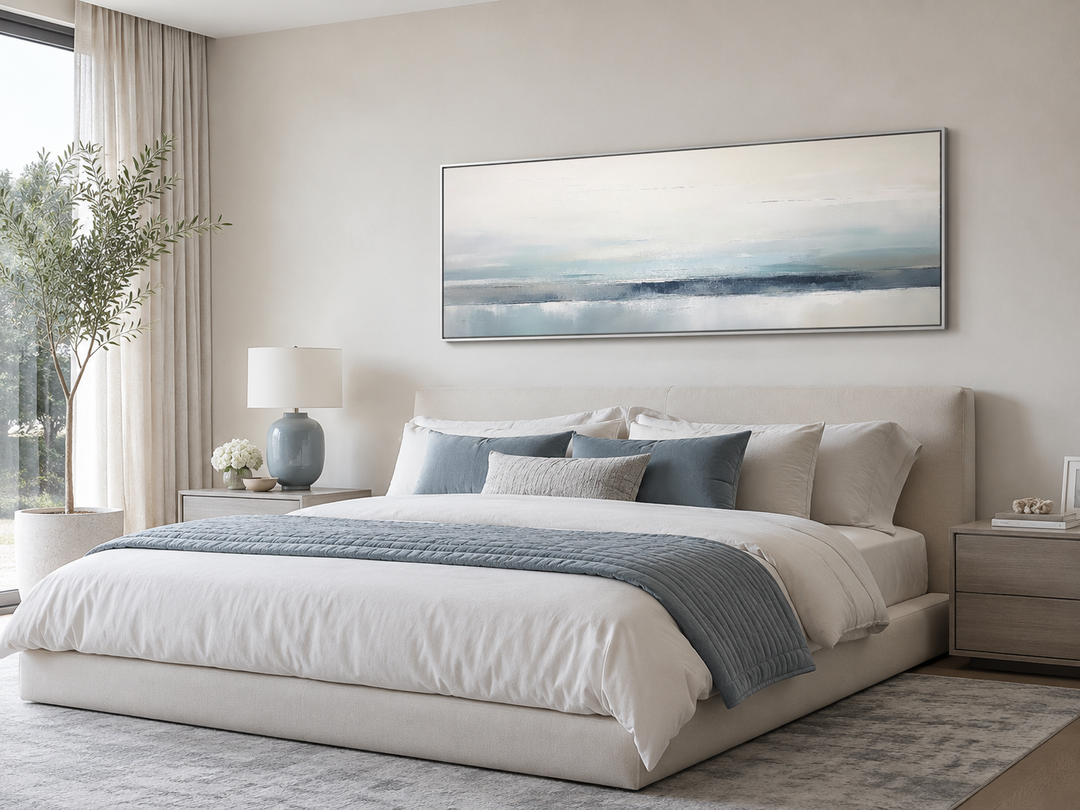 Blue gray calm coastal framed canvas wall art in a horizontal layout over a bed.