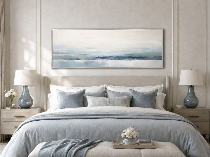 Blue gray calm coastal over bed framed canvas wall art in a modern bedroom setting.