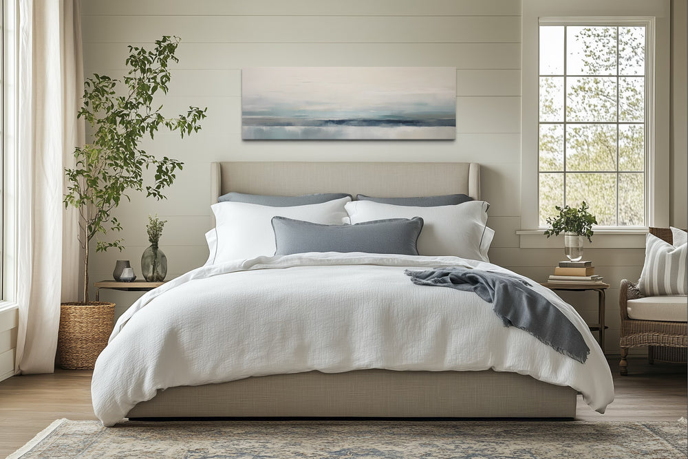 Blue Gray Calm Coastal horizontal framed canvas wall art hanging above a bed in a serene bedroom.