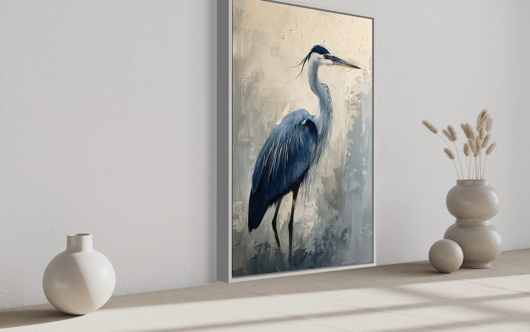 Blue Heron Abstract Painting Coastal Framed Canvas Wall Art in a vertical frame on a neutral wall.