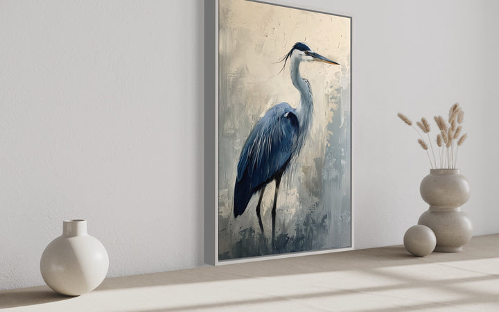 Blue Heron Abstract Painting Coastal Framed Canvas Wall Art in a vertical frame on a neutral wall.