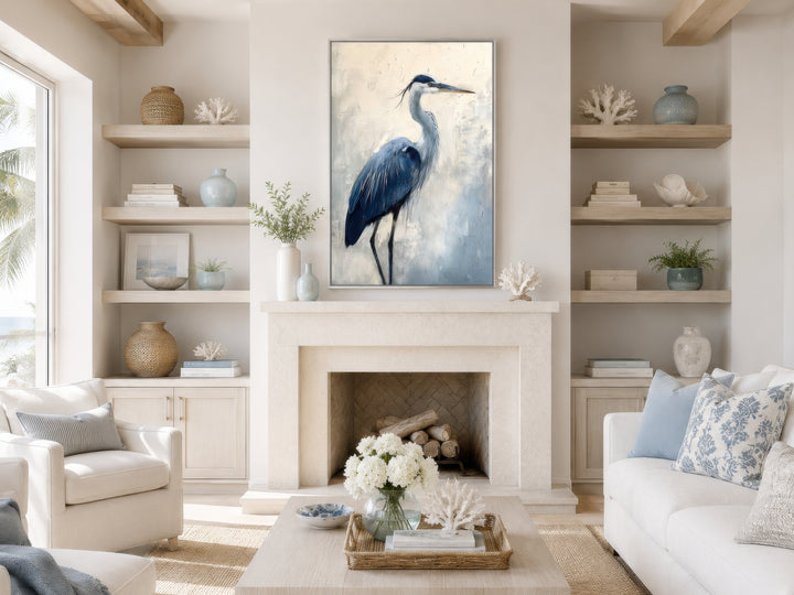 Vertical framed canvas wall art of a blue heron abstract painting above a stone fireplace.