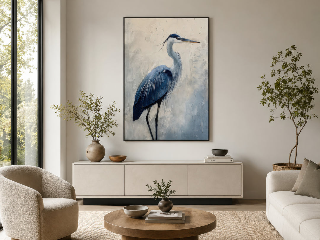 Blue heron abstract painting in a black frame hanging above a modern sideboard in a living room.