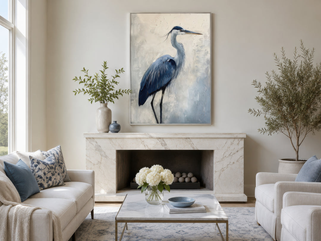 Blue heron abstract framed canvas wall art hanging above a marble fireplace in a coastal living room.