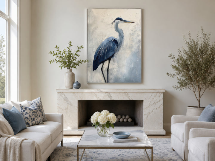 Blue heron abstract framed canvas wall art hanging above a marble fireplace in a coastal living room.