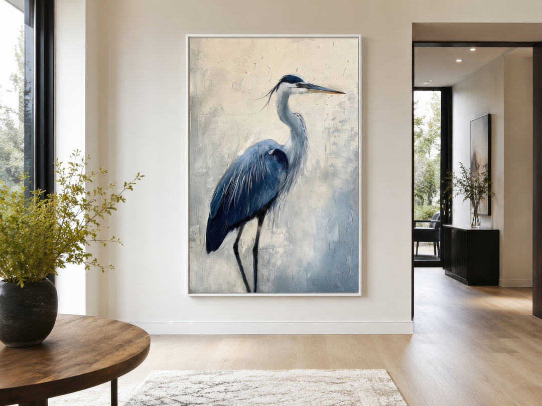 Vertical framed canvas wall art featuring an abstract blue heron painting in a modern living room.