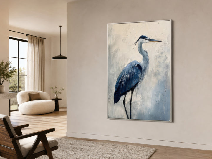 Vertical framed canvas wall art featuring an abstract blue heron painting in a modern living room.