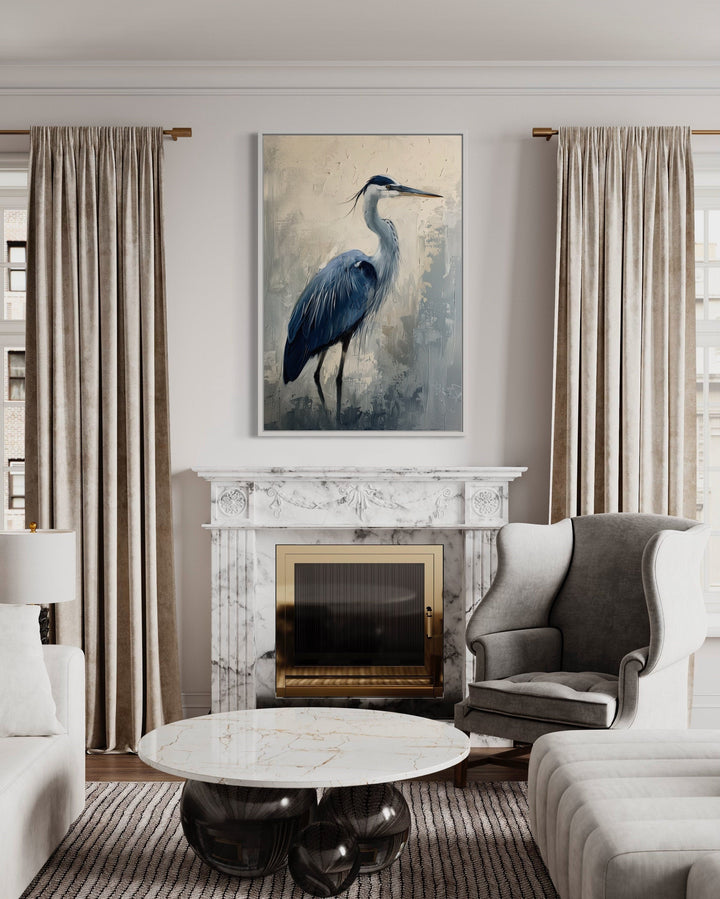 Blue heron abstract painting in a white frame hanging above a marble fireplace in a living room.
