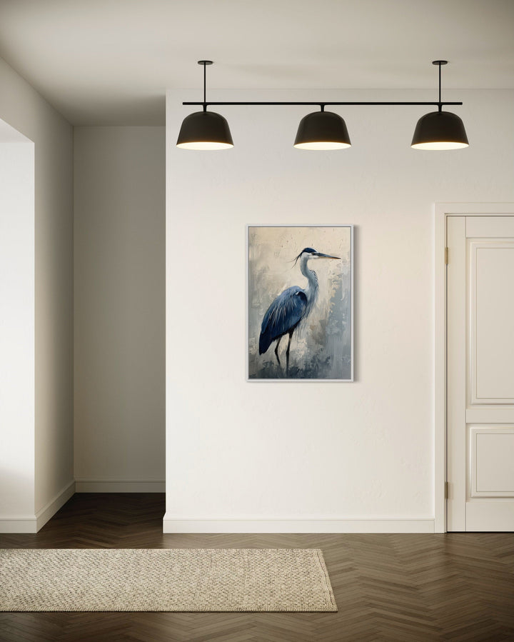 Vertical framed canvas wall art of a blue heron abstract painting in a modern white hallway.