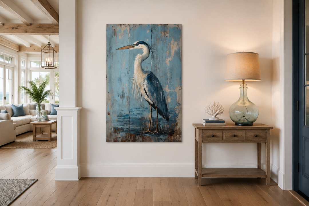 Blue heron painting on rustic wood-textured canvas wall art in a coastal living room setting.